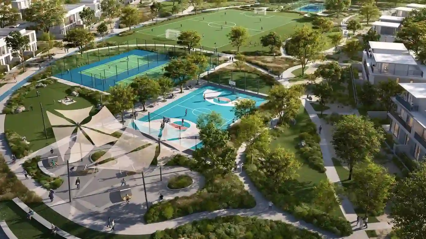 Alva at The Valley — aerial marketing still of Sports Village courts, pitch and adjacent low-rise blocks in The Valley