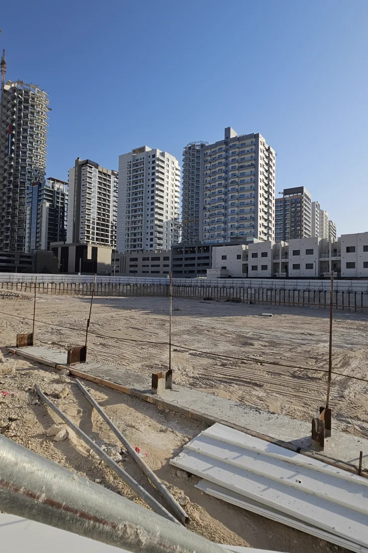 Noble Crest Residences — Propsearch May 2026 construction photo of the excavated plot in JVC