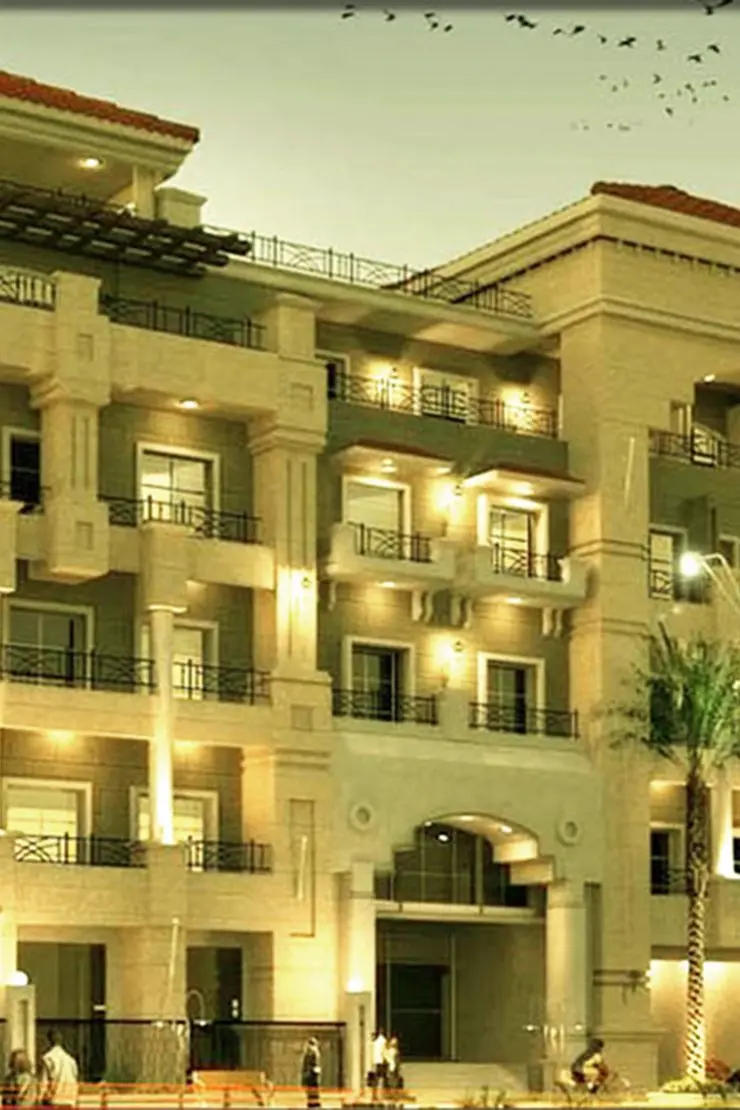 Paradise One — night exterior marketing still of the illuminated façade and entrance
