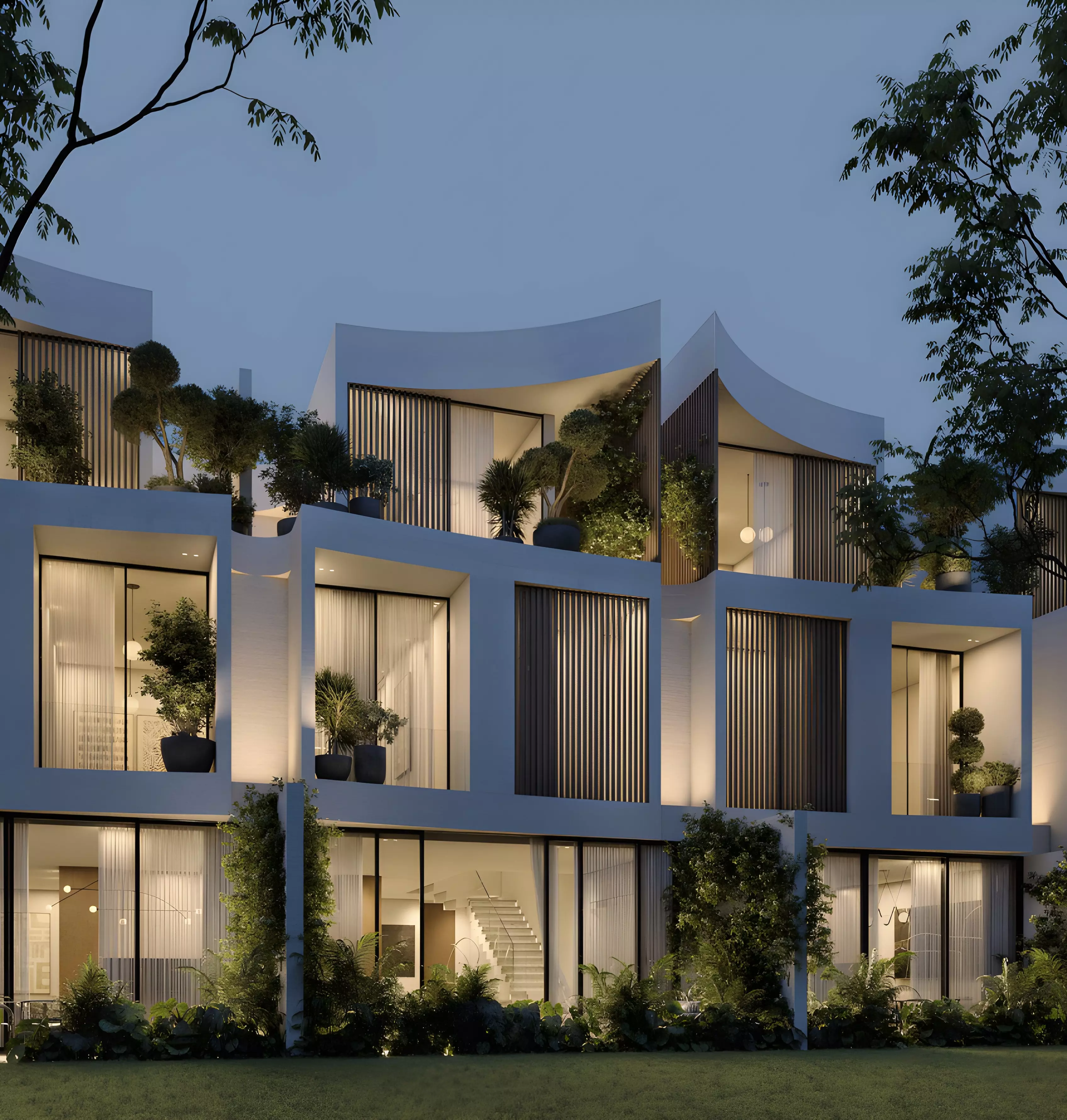 The Rise at Lunaya — night exterior of maisonette row with lit interiors and vertical louvers